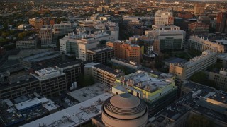 AX146_051E - 6k aerial stock footage approaching Massachusetts Institute of Technology, Massachusetts, sunset