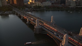 6k aerial stock footage tracking a commuter train across the Longfellow Bridge, Boston, Massachusetts, sunset Aerial Stock Footage | AX146_068E