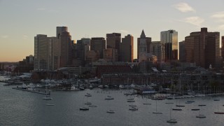 6k aerial stock footage flying by the downtown skyline, Downtown Boston, Massachusetts, sunset Aerial Stock Footage | AX146_080E