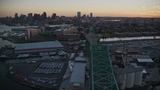 6k aerial stock footage flying by Tobin Memorial Bridge, reveal downtown skyline, Charlestown, Massachusetts, sunset Aerial Stock Footage | AX146_099E