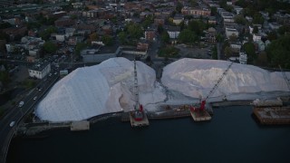 AX146_104 - 6k aerial stock footage approaching a waterfront industrial area, cranes, Chelsea, Massachusetts, sunset