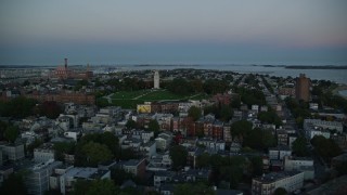 6k aerial stock footage of Dorchester Heights Monument, row houses, South Boston, Massachusetts, twilight Aerial Stock Footage | AX146_115E