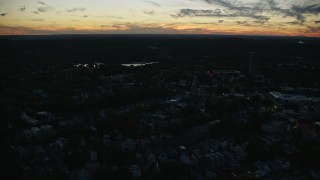 AX146_151 - 6k aerial stock footage flying by neighborhood, Jamaica Pond, Jamaica Plain, Massachusetts, twilight