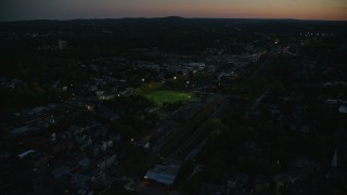 6k aerial stock footage flying by sports fields, tilt down, Jamaica Plain, Massachusetts, twilight Aerial Stock Footage | AX146_152