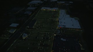 6k aerial stock footage approaching an office building and tilt to strip mall, Westwood, Massachusetts, night Aerial Stock Footage | AX146_163E