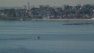 AX147_015 - 6K aerial stock footage of a fishing boat on Broad Sound, revealing waterfront homes, Revere, Massachusetts