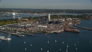 AX147_035 - 6K aerial stock footage flying by a natural gas power plant along the harbor, Salem, Massachusetts