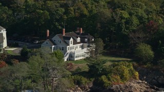 6K aerial stock footage approaching an oceanfront mansion among trees, autumn, Beverly, Massachusetts Aerial Stock Footage | AX147_055