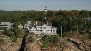 6K aerial stock footage revealing oceanfront homes and lighthouse among trees, Manchester-by-the-Sea, Massachusetts Aerial Stock Footage | AX147_064E