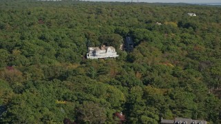 6K aerial stock footage flying by mansion, dense trees, autumn, Manchester-by-the-Sea, Massachusetts Aerial Stock Footage | AX147_078