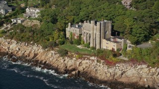 AX147_081 - 6K aerial stock footage flying by Hammond Castle, rocky coastline, Gloucester, Massachusetts