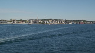 6K aerial stock footage flying low over Gloucester Harbor, approach coastal town, Gloucester, Massachusetts Aerial Stock Footage | AX147_084E