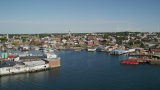 6K aerial stock footage flying by coastal town, small warehouse buildings, Gloucester, Massachusetts Aerial Stock Footage | AX147_087