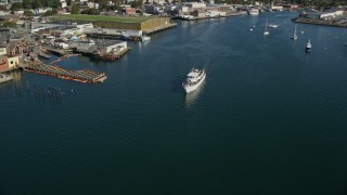 6K aerial stock footage tracking a ferry by a small coastal town, Gloucester, Massachusetts Aerial Stock Footage | AX147_088