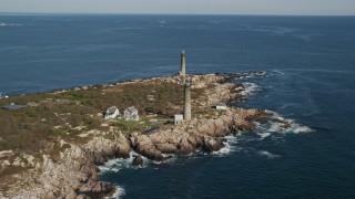 AX147_109E - 6K aerial stock footage approaching an island with two lighthouses, Thatcher Island, Massachusetts