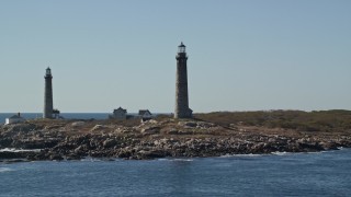 AX147_112E - 6K aerial stock footage orbiting two light houses on Thatcher Island, Massachusetts