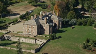 AX147_141E - 6K aerial stock footage of The Great House at Crane Estate and Castle Hill among trees in autumn, Ipswich, Massachusetts