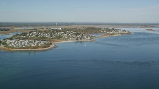 AX147_150 - 6K aerial stock footage approaching a coastal town in autumn, Ipswich, Massachusetts