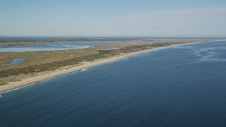 AX147_151 - 6K aerial stock footage following beach and coastline, Newbury, Massachusetts