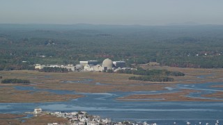 AX147_152E - 6K aerial stock footage of a nuclear power plant along the water, autumn, Seabrook, New Hampshire