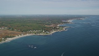 AX147_158E - 6K aerial stock footage of autumn trees against a coastal community and coastline, Hampton, New Hampshire