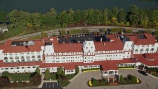 AX147_171 - 6K aerial stock footage approaching Wentworth By The Sea hotel from the marina in autumn, New Castle, New Hampshire