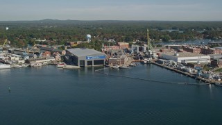 6K aerial stock footage flying by a naval shipyard in autumn, Kittery, Maine Aerial Stock Footage | AX147_174