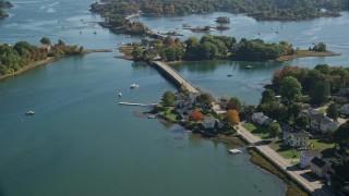 6K aerial stock footage flying over small bridge, waterfront homes in autumn, Portsmouth, New Hampshire Aerial Stock Footage | AX147_186E