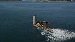 AX147_196 - 6K aerial stock footage flying away from lighthouse in the water, Kittery, Maine