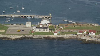 AX147_198 - 6K aerial stock footage approaching lighthouse and emergency helicopter, New Castle, New Hampshire