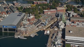 AX147_202 - 6K aerial stock footage flying by Portsmouth Naval Shipyard, submarine, Kittery, Maine