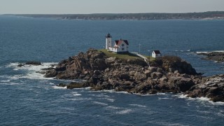 6K aerial stock footage orbiting Cape Neddick Light, coastal town in autumn, York, Maine Aerial Stock Footage | AX147_238