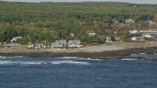 6K aerial stock footage flying by oceanfront homes, colorful dense forest, autumn, York, Maine Aerial Stock Footage | AX147_245