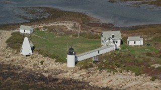 6K aerial stock footage flying by Goat Island Light, autumn, Kennebunkport, Maine Aerial Stock Footage | AX147_261E