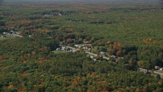 6K aerial stock footage flying by rural homes off of Guinea Road, autumn trees, Biddeford, Maine Aerial Stock Footage | AX147_278