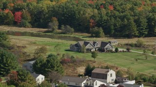 6K aerial stock footage flying by riverfront rural homes, colorful forest, Biddeford, Maine Aerial Stock Footage | AX147_290