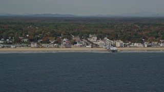 AX147_296E - 6K aerial stock footage flying by beach, pier and Palace Playland, autumn, Old Orchard Beach, Maine