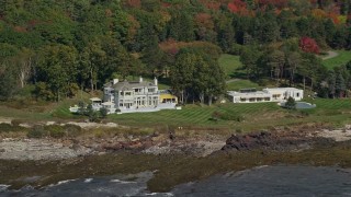 6K aerial stock footage flying by oceanfront mansions, colorful autumn trees, Cape Elizabeth, Maine Aerial Stock Footage | AX147_301