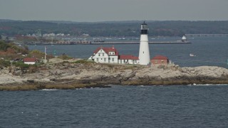 AX147_309 - 6K aerial stock footage flying by Portland Head Light, autumn, Cape Elizabeth, Maine