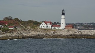 AX147_310 - 6K aerial stock footage flying by Portland Head Light, autumn, Cape Elizabeth, Maine