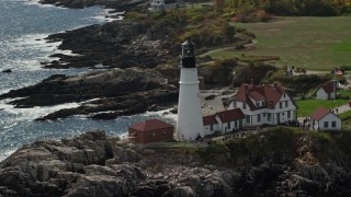 AX147_312E - 6K aerial stock footage orbiting Portland Head Light, autumn, Cape Elizabeth, Maine