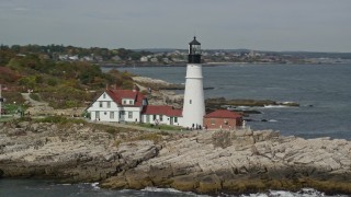 6K aerial stock footage orbiting Portland Head Light, revealing rock formations, Cape Elizabeth, Maine Aerial Stock Footage | AX147_314E