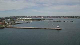 6K aerial stock footage flying by Spring Point Ledge Light, coastal city, autumn, Portland, Maine Aerial Stock Footage | AX147_318E