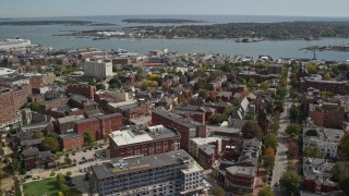 AX147_328E - 6K aerial stock footage orbiting downtown, colorful autumn trees, Portland, Maine