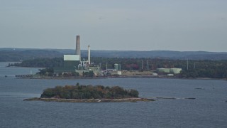 AX147_368 - 6K aerial stock footage flying by Wyman Energy Center on a cloudy day in autumn, Yarmouth, Maine