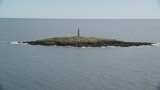 AX147_377 - 6K aerial stock footage flying by a lighthouse on Little Mark Island, Atlantic Ocean, Harpswell, Maine