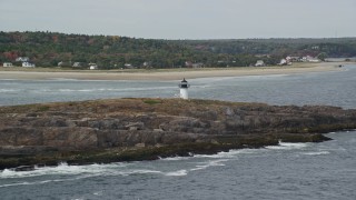 6K aerial stock footage approaching Pond Island Light, Pond Island, autumn, Phippsburg, Maine Aerial Stock Footage | AX147_395