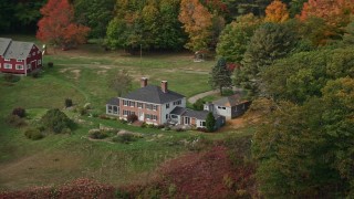 6K aerial stock footage flying by an isolated waterfront home, colorful autumn trees, Phippsburg, Maine Aerial Stock Footage | AX147_407