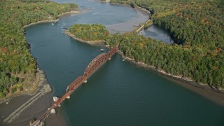 6K aerial stock footage flying by a small bridge spanning Sheepscot River, autumn, Newcastle, Maine Aerial Stock Footage | AX148_006