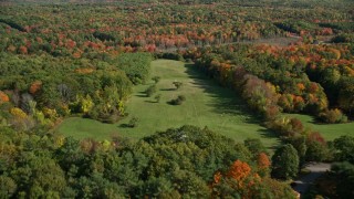 AX148_007 - 6K aerial stock footage flying by sheep, small farm surrounded by autumn trees, Newcastle, Maine